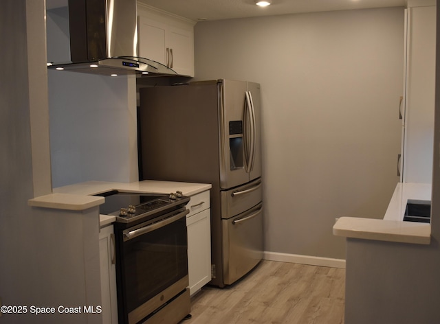 kitchen featuring ventilation hood, white cabinetry, appliances with stainless steel finishes, and light hardwood / wood-style floors