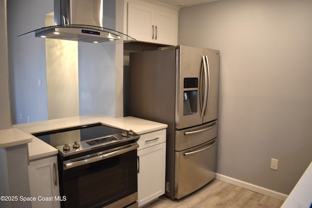 kitchen featuring light hardwood / wood-style flooring, stainless steel appliances, white cabinets, and island exhaust hood