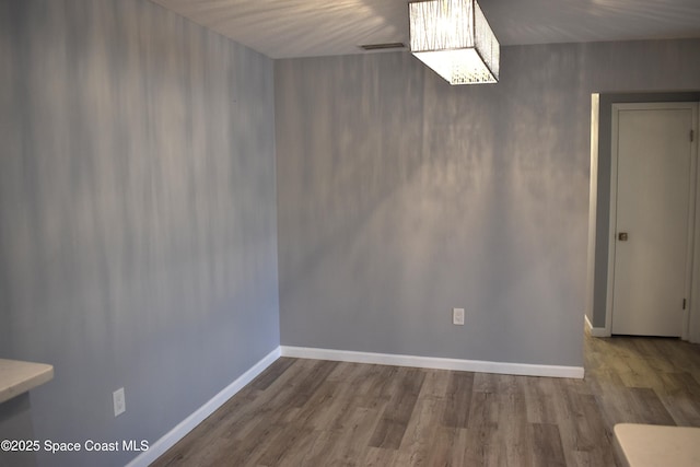 unfurnished dining area with wood-type flooring