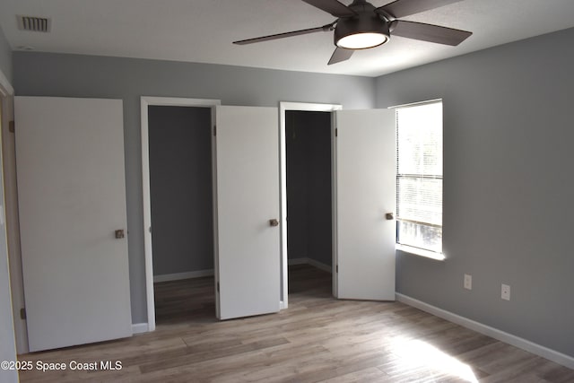 unfurnished bedroom with ceiling fan and light hardwood / wood-style flooring