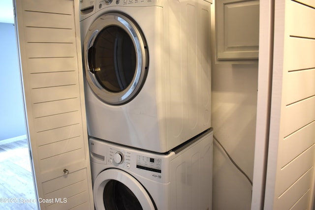 laundry area featuring stacked washer / drying machine