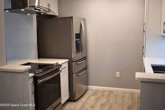 kitchen with stainless steel appliances, white cabinetry, exhaust hood, and light hardwood / wood-style floors