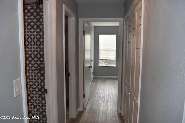 hallway with light wood-type flooring