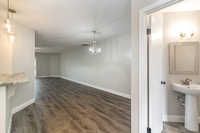 interior space featuring dark hardwood / wood-style floors, an inviting chandelier, and sink