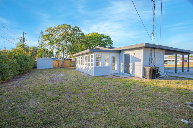 exterior space featuring a carport, a shed, and a yard