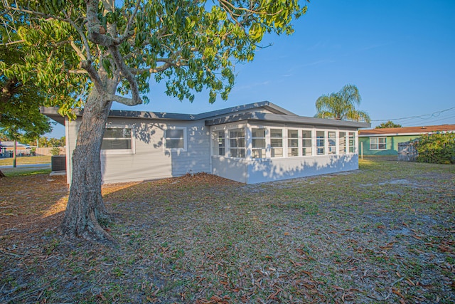 view of front of house with cooling unit and a sunroom