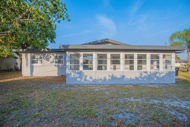 rear view of property with a sunroom