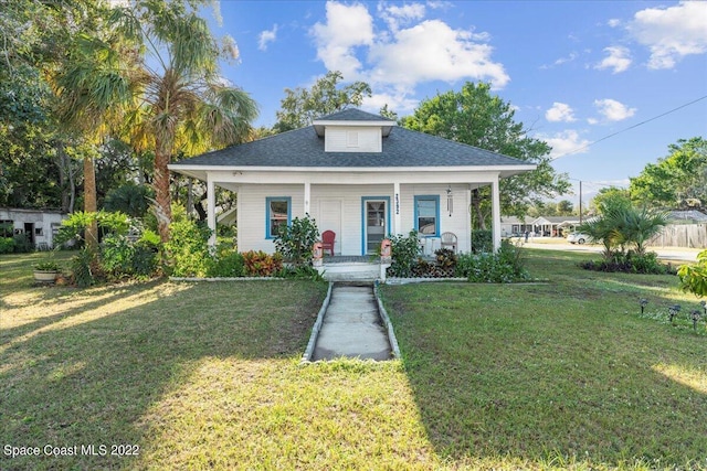 bungalow-style house with a front lawn and a porch