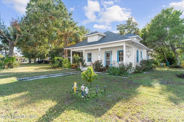 view of front of property with covered porch and a front yard