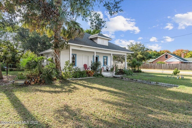 view of front of home with a front yard and covered porch