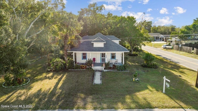 cape cod house with a front lawn