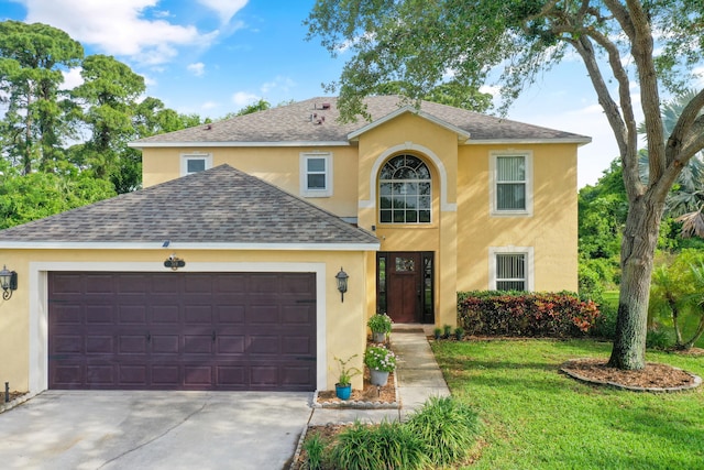 view of front of property with a garage and a front yard