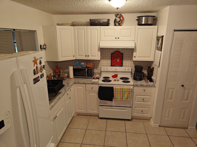 kitchen with light stone counters, white cabinetry, light tile floors, backsplash, and white appliances