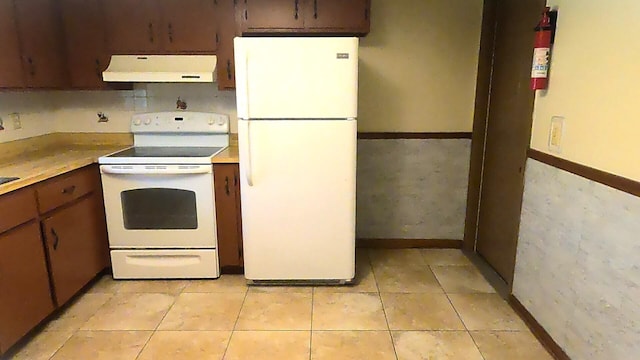 kitchen with light tile flooring and white appliances