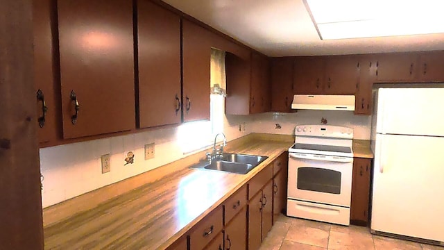 kitchen with white appliances, sink, and light tile floors