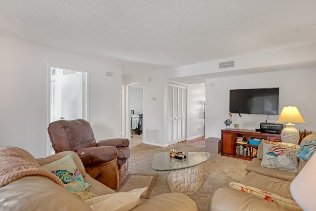 living room with light colored carpet and a textured ceiling