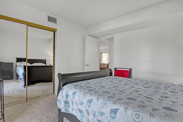 bedroom with a closet and light carpet