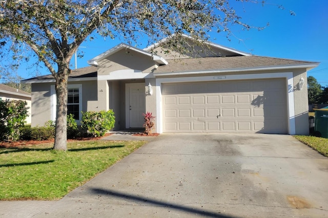 single story home with a garage and a front yard