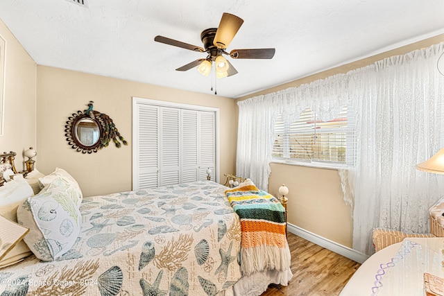 bedroom featuring hardwood / wood-style floors, ceiling fan, and a closet