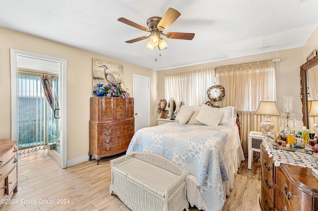 bedroom with access to exterior, light wood-type flooring, and ceiling fan