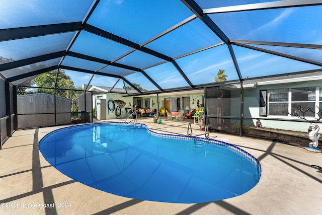 view of pool featuring a patio and glass enclosure