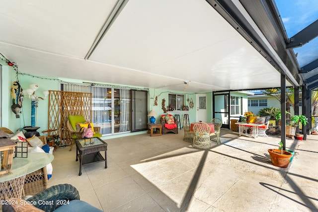 view of patio with glass enclosure