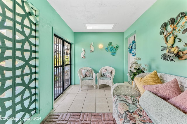 sitting room with light tile patterned flooring and a skylight