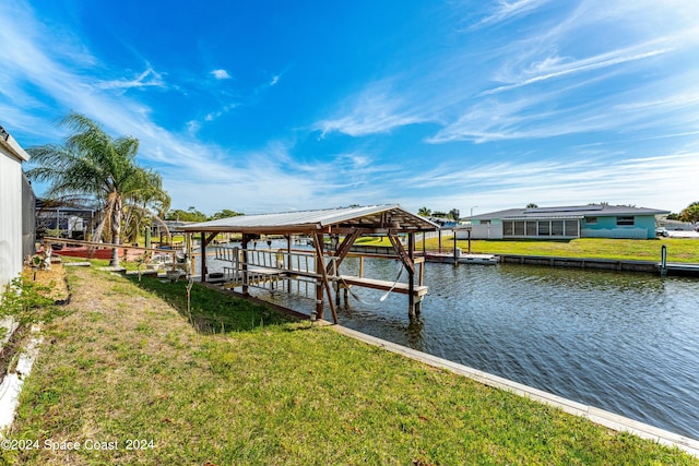 dock area with a yard and a water view