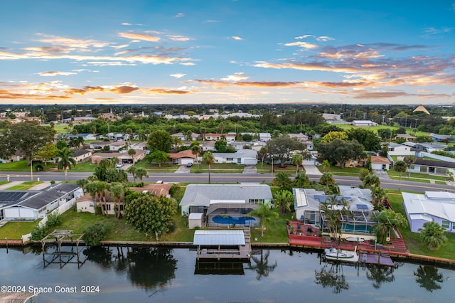 aerial view at dusk with a water view