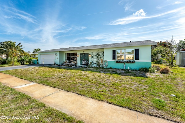 ranch-style house featuring a garage and a front lawn