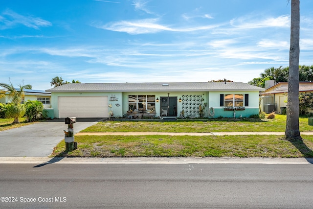 ranch-style house with a garage and a front lawn