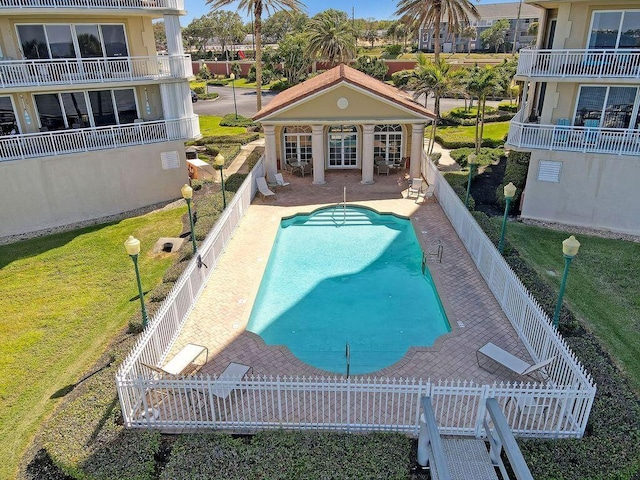 view of swimming pool with a lawn and a patio