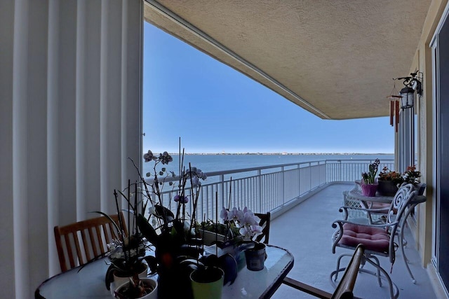 balcony featuring a water view