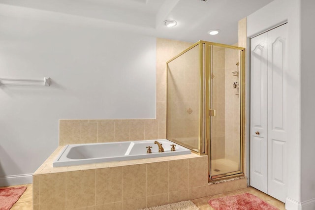 bathroom featuring shower with separate bathtub and tile floors