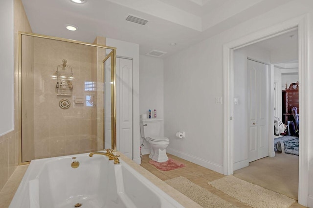 bathroom with shower with separate bathtub, tile floors, and toilet