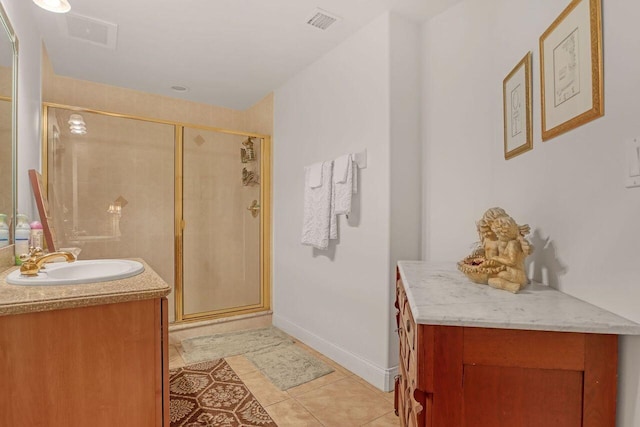 bathroom with tile flooring, a shower with door, and vanity