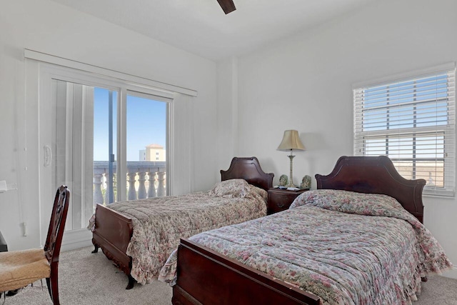 bedroom featuring ceiling fan, light carpet, and multiple windows