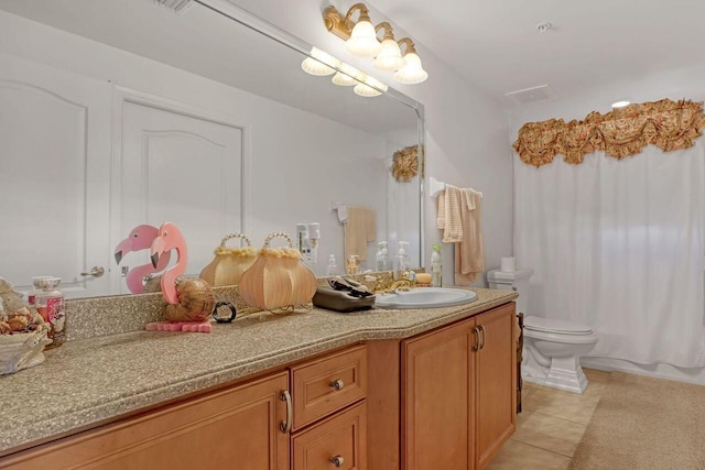 bathroom featuring vanity, tile flooring, and toilet