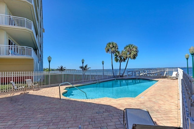 view of swimming pool featuring a patio area