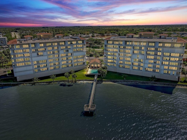 aerial view at dusk with a water view