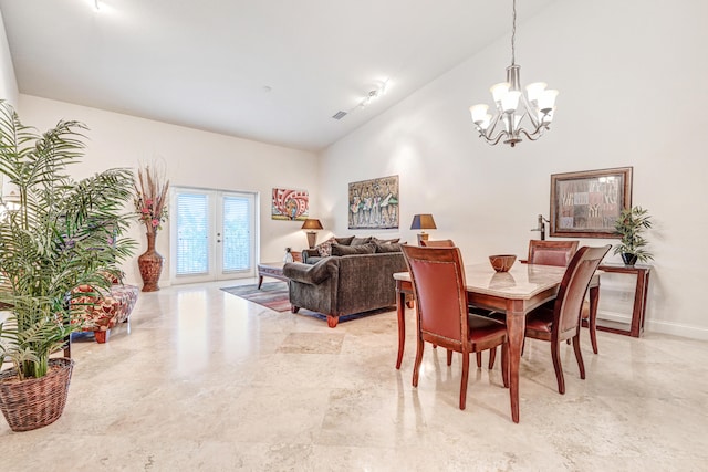 dining area featuring french doors, a chandelier, high vaulted ceiling, and rail lighting