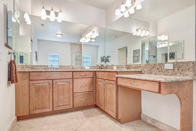 bathroom with a shower with door and vanity