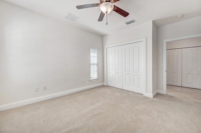 unfurnished bedroom with a closet, ceiling fan, and light colored carpet