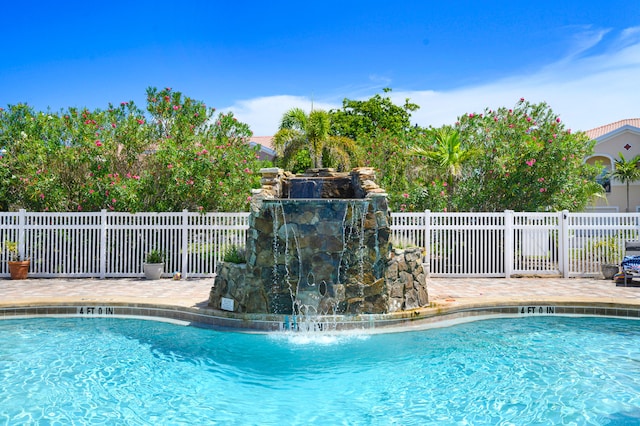 view of swimming pool with a patio area and pool water feature