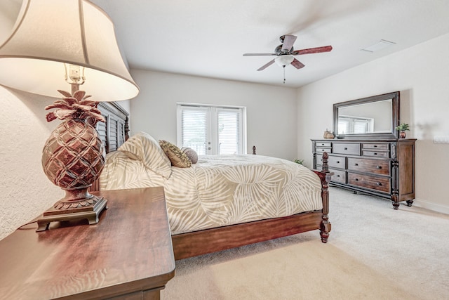 bedroom featuring light carpet, ceiling fan, and french doors