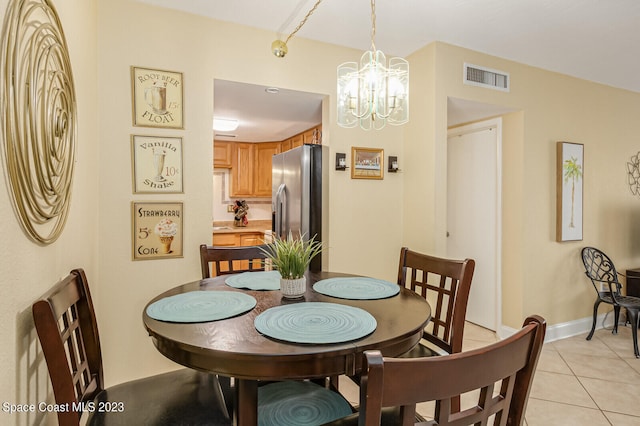 tiled dining area featuring a notable chandelier