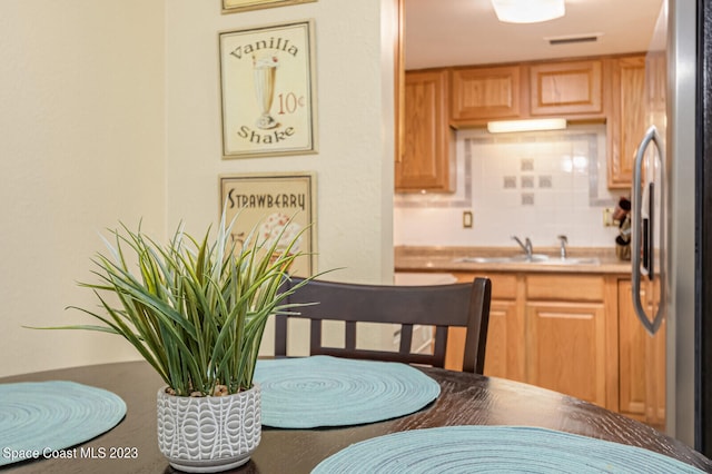 kitchen with tasteful backsplash and stainless steel refrigerator