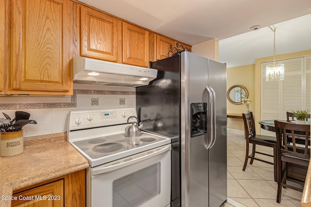 kitchen with hanging light fixtures, light tile flooring, an inviting chandelier, white electric stove, and tasteful backsplash