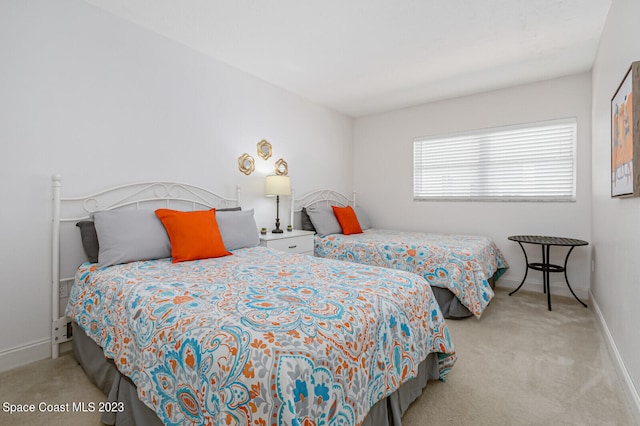 bedroom featuring light carpet