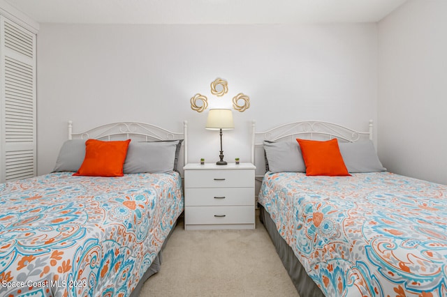 bedroom featuring light colored carpet